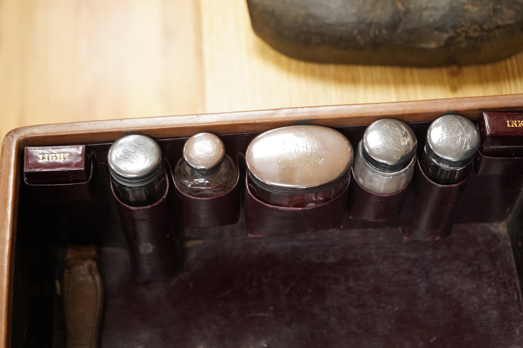 A leather toilet case with silver mounted contents, 61cm wide